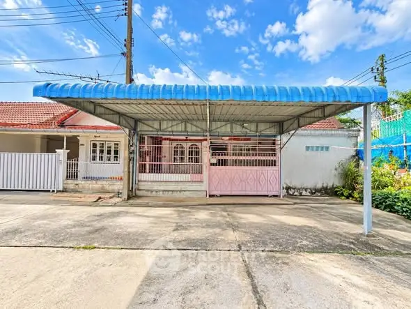 Charming suburban home with covered carport and vibrant exterior, perfect for family living.