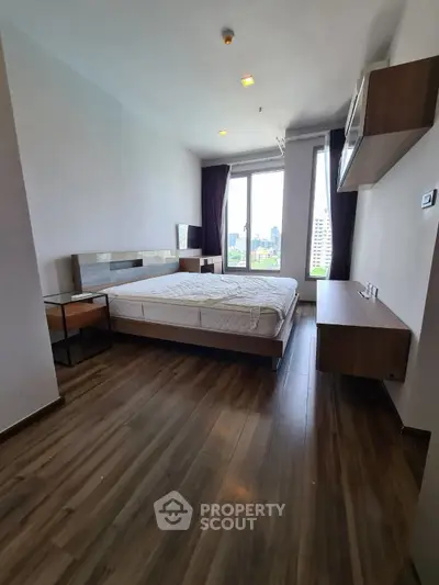 Spacious bedroom with city view and modern furnishings