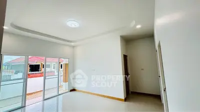 Spacious modern living room with large windows and natural light