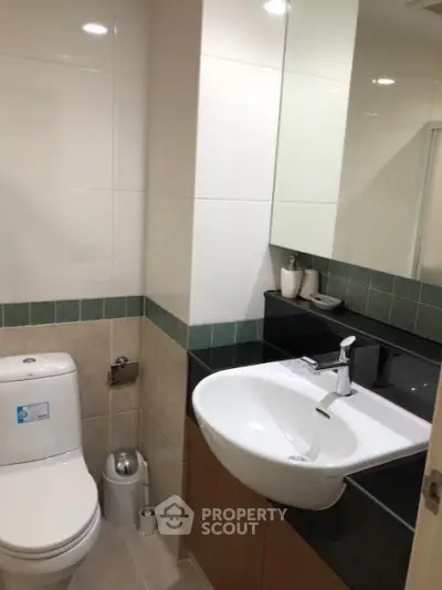 Modern bathroom with sleek sink and toilet in stylish apartment