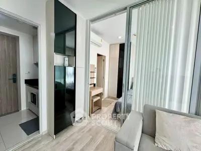 Modern apartment interior with sleek design, featuring a cozy living area and stylish bedroom.