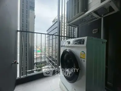 High-rise balcony with washing machine and city view, perfect for urban living.