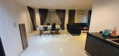 Spacious modern living room with dining area and sleek furnishings