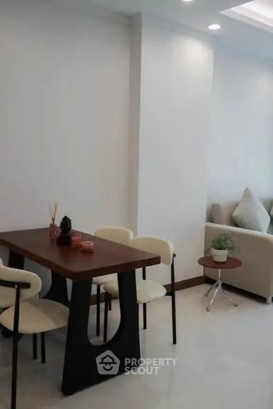 Modern dining area with sleek table and chairs in a stylish apartment interior.