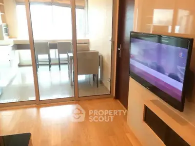 Modern living room with glass partition and wall-mounted TV