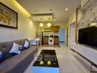Modern living room with open kitchen, stylish decor, and washing machine, perfect for urban living.