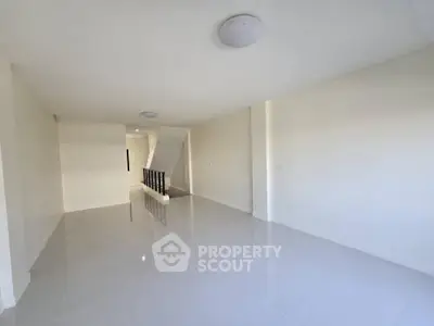 Spacious and bright unfurnished living area with glossy tiled floors and a minimalist design, perfect for custom interior styling.
