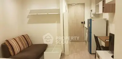 Modern studio apartment with compact living area and kitchen appliances