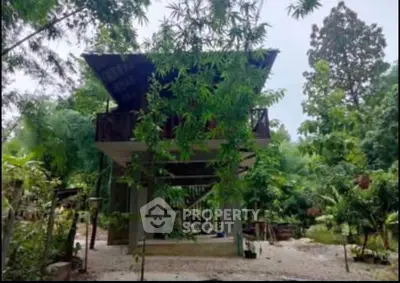 Charming rustic two-story house surrounded by lush greenery, perfect for nature lovers seeking tranquility.