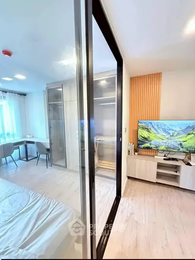 Modern bedroom with glass partition, stylish decor, and natural light