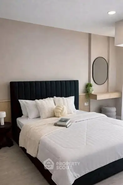 Modern bedroom with elegant decor and plush bedding in a stylish apartment.