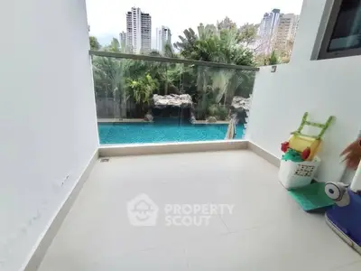 Spacious balcony with pool view in modern apartment