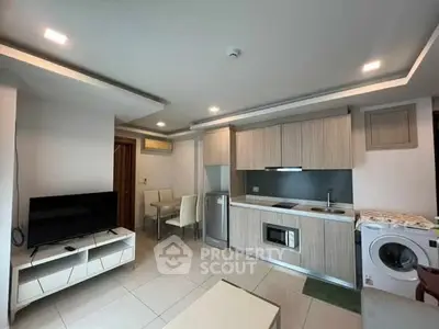 Modern open-plan kitchen and living area with sleek appliances and stylish decor.