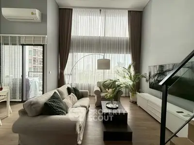 Spacious modern living room with high ceilings and large windows