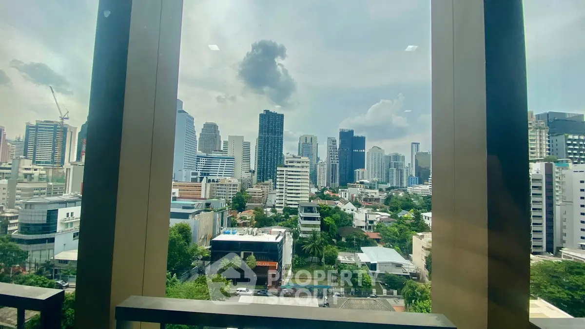 Stunning cityscape view from high-rise building window, showcasing urban skyline and lush greenery.