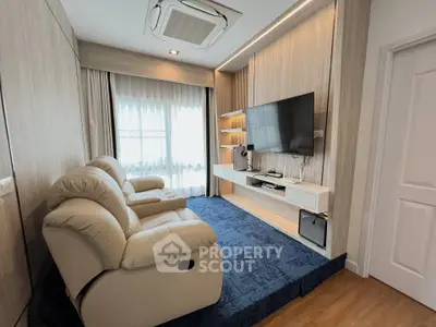 Modern living room with cozy recliner and wall-mounted TV, featuring elegant wood paneling and plush blue carpet.