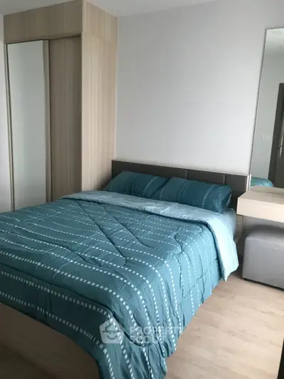 Cozy bedroom with modern decor and stylish bedding in a contemporary apartment.