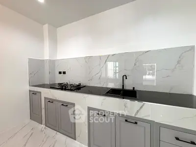 Modern kitchen with sleek marble backsplash and gas stove