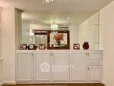 Elegant living room with stylish cabinetry and decorative mirror wall