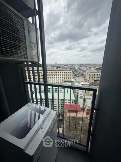 High-rise balcony with city view and washing machine, perfect for urban living.