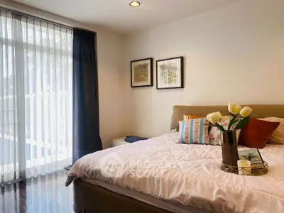 Cozy bedroom with elegant decor and natural light through large window
