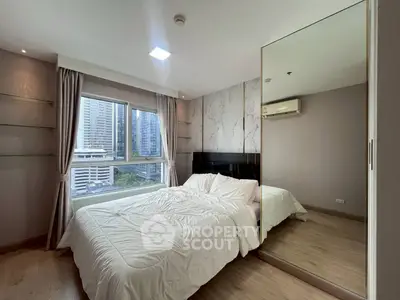 Modern bedroom with city view and mirrored wardrobe