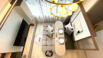 Modern living room with elegant chandelier and cozy seating area