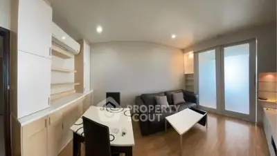 Modern living room with sleek furniture and ample storage in a cozy apartment.