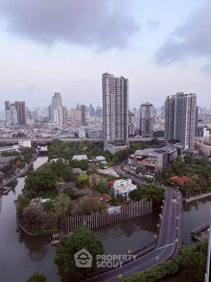 Stunning cityscape view showcasing high-rise buildings and lush greenery along a winding river.
