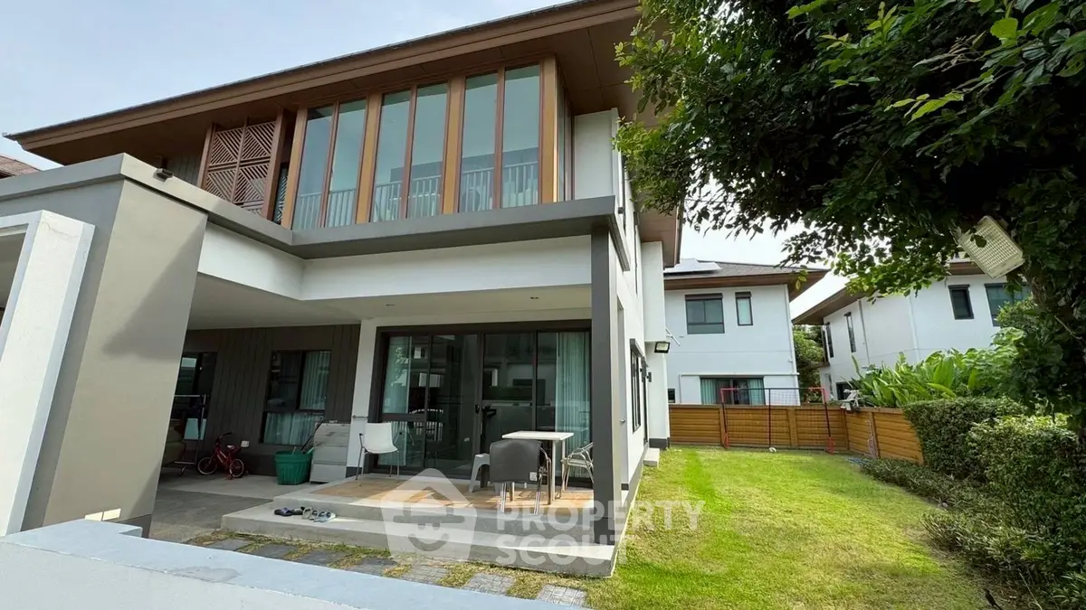 Modern two-story house with spacious garden and patio area