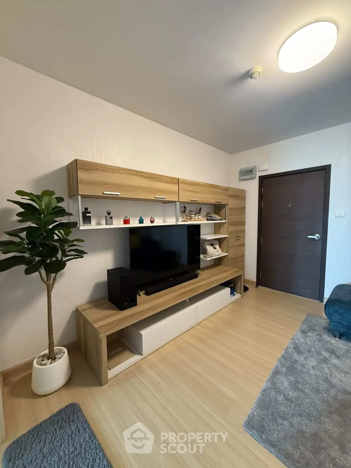 Modern living room with stylish wooden entertainment unit and cozy decor