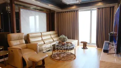 Luxurious living room with plush leather seating and elegant drapery, complemented by rich wooden flooring and modern decor.
