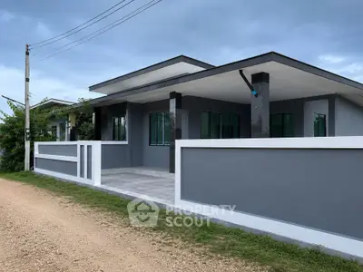Modern single-story house with sleek design and spacious front patio, perfect for contemporary living.