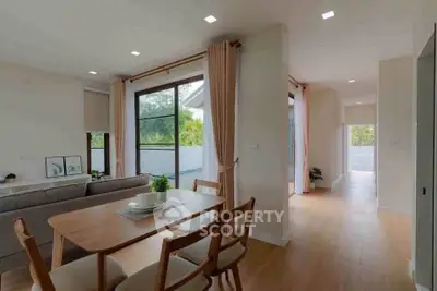 Spacious open-plan living and dining area with natural light and modern decor.