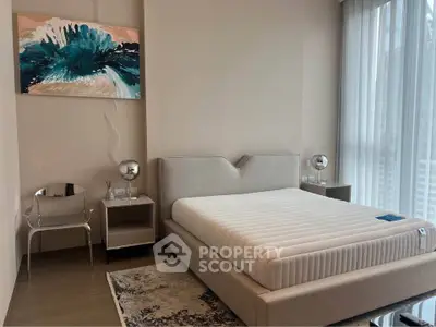 Modern bedroom with stylish decor and large windows for natural light.