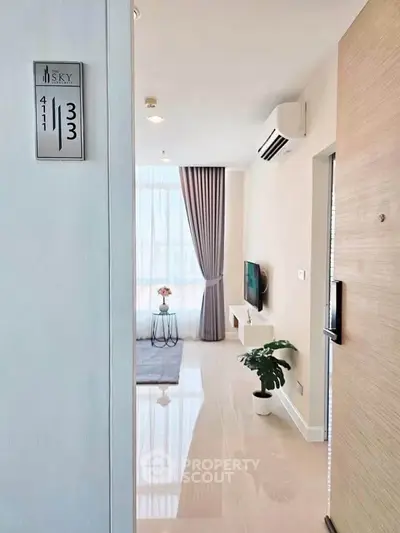 Modern apartment entrance with sleek interior design and natural light