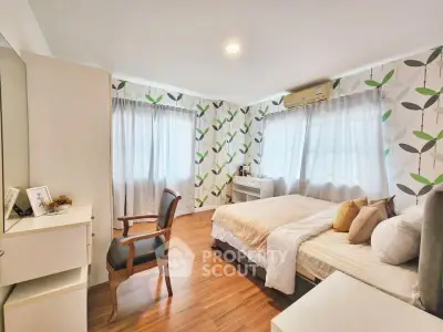 Spacious bedroom with modern decor and natural light