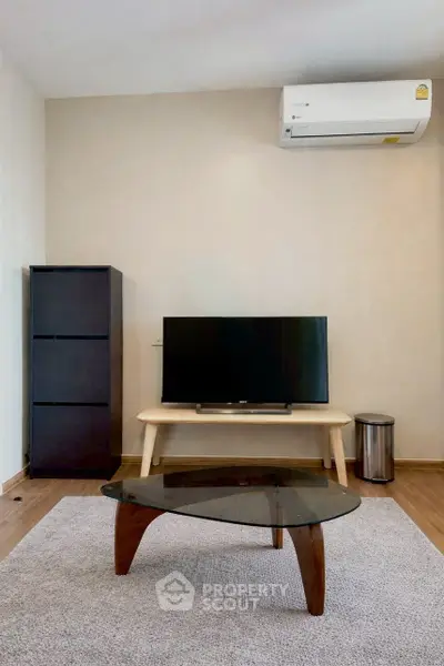Modern living room with sleek furniture and air conditioning, perfect for comfortable living.