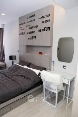 Modern bedroom with stylish decor and cozy bedding in a contemporary apartment.