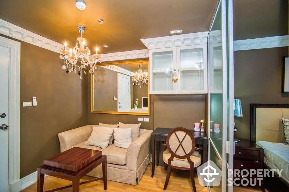 Elegant living room with chandelier and cozy seating area