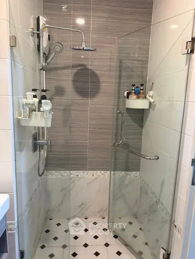 Modern bathroom with glass shower enclosure and stylish tile design