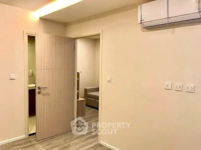 Modern apartment interior with air conditioning and wooden flooring