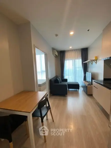 Modern living room with open kitchen and cozy seating area