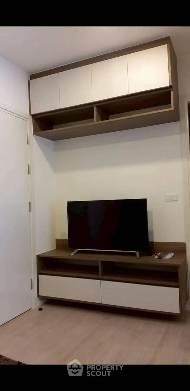 Modern living room with sleek TV unit and ample storage space