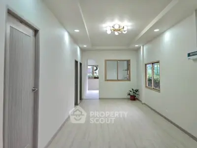 Spacious modern living room with elegant lighting and large windows for natural light.