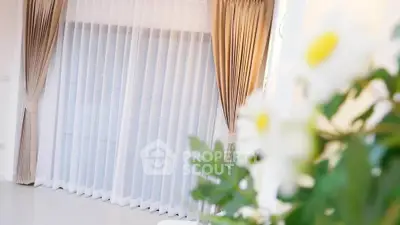Elegant interior with floor-to-ceiling curtains and soft lighting, perfect for a cozy living space.