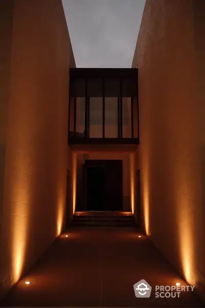 Modern architectural entrance with dramatic lighting and sleek design