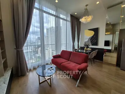Modern living room with red sofa and city view through large windows