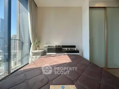 Modern bedroom with large window and city view, featuring sleek design and natural light.