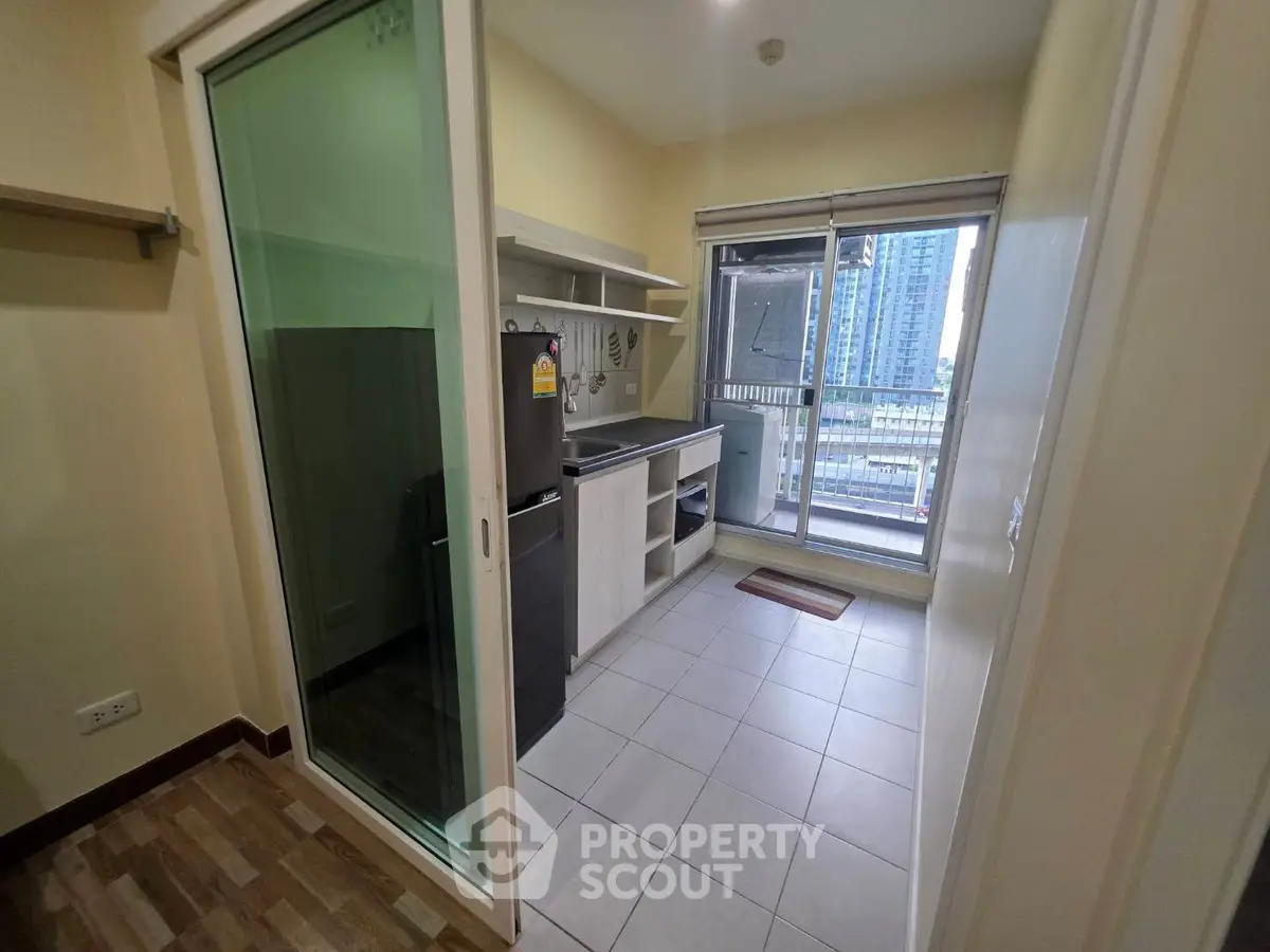 Modern kitchen with balcony view in high-rise apartment